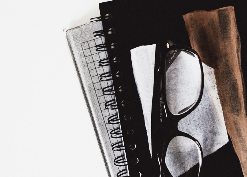 Notebook with glasses on top
